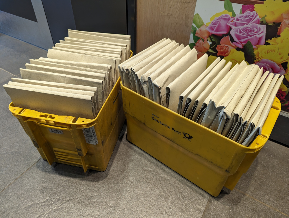 Many packages in two Deutsche Post transport boxes